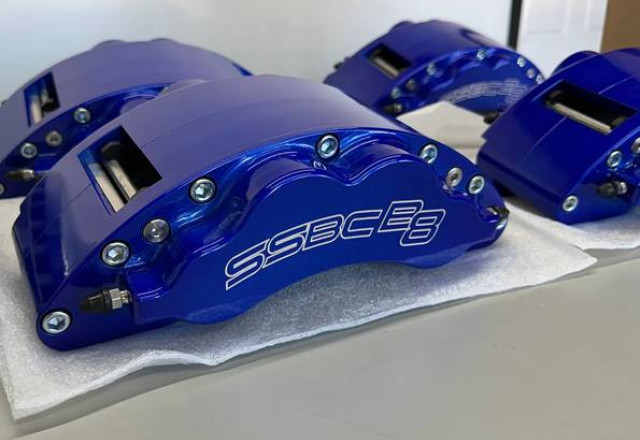 Set of blue SSBC B8 Barbarian calipers resting on foam packing