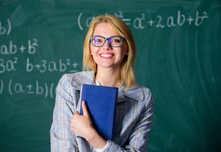 Happy Student in Front of Blackboard
