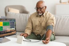 Senior Man Using Addison Care to take blood pressure