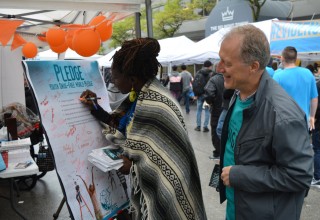 People mobilize to handle British Columbia's opioid crisis at the Foundation for a Drug-Free World booth at British Columbia's Recovery Day Festival.