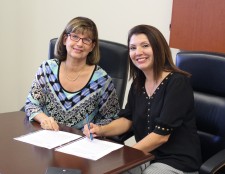 Lynn Fernandez, Chief Credit Officer at Lendistry (right) making it official.