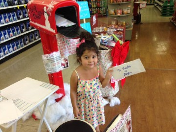 Three-year-old Alexa Martinez sends her letter to Santa at the Crown Ace location in Huntington Beach, Calif.