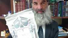 Rabbi Avraham Goldstein Holding the World Peace Torah