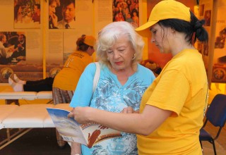 Volunteer Ministers helps a visitor at the tent