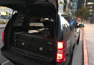 Trikke Defender folded and inside of Police car trunk