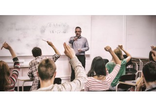 College Students Raising Their Hands in Class